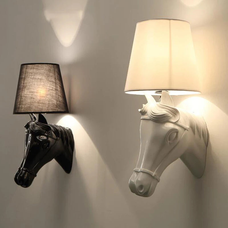 Two horse-shaped wall lamps, one black and one white, on a wall. @ ghoddosh.com
