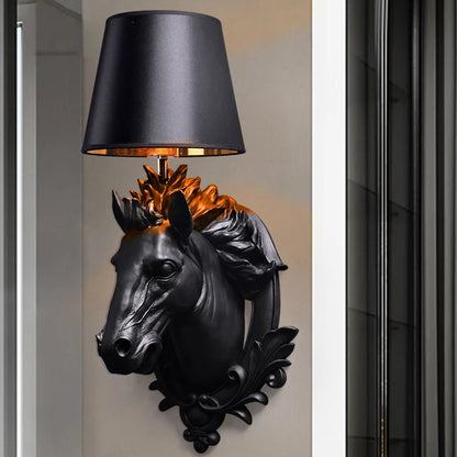 Decorative wall lamp shaped like a horse head with a black shade on a neutral wall. @ ghoddosh.com