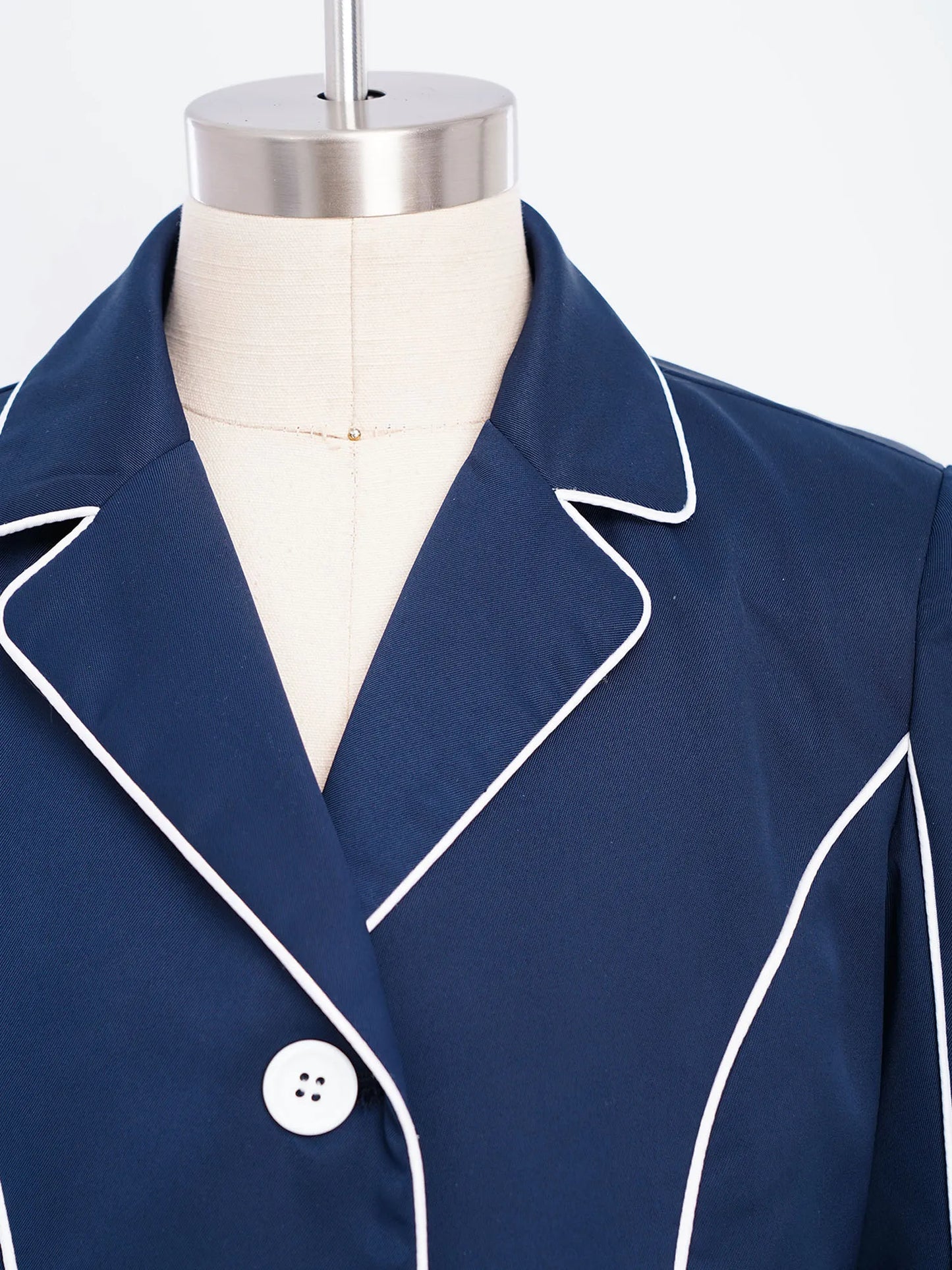 Navy blue blazer with white piping on a mannequin @ ghoddosh.com