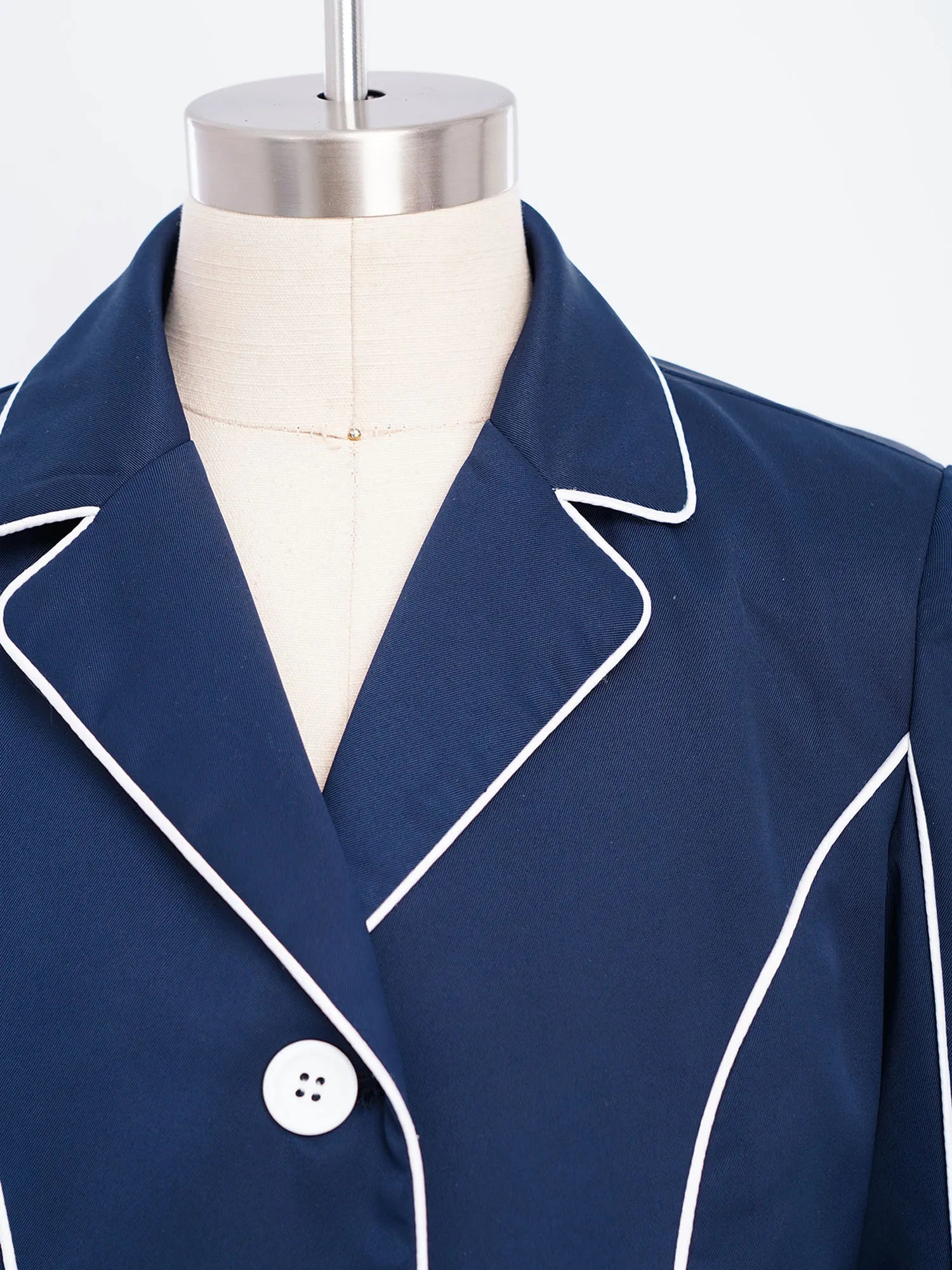 Navy blue blazer with white piping on a mannequin @ ghoddosh.com