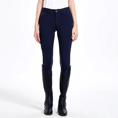 Person wearing navy riding pants with a white background . Ghoddosh 